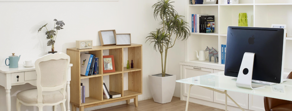 Home office A space to drink tea, a trendy bookshelf, and an Apple computer on the workdesk -- this is a home office.