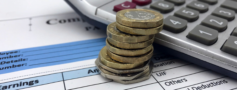 Decorative image of coins, accounting sheets, and a calculator.