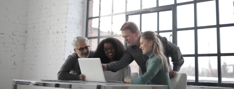 Unemployed Happy team working together in front of a laptop