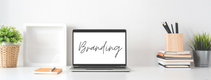 Clean, minimal, modern workspace. The laptop screen reads, "Branding," in cursive.