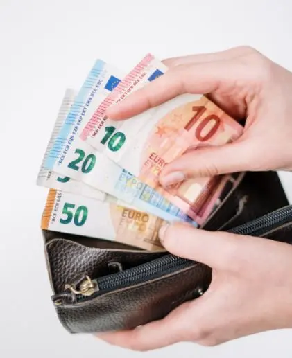 money bills Money bills being taken out of a black leather wallet.