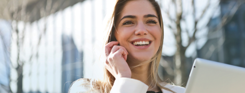 A happy woman talking over a phone